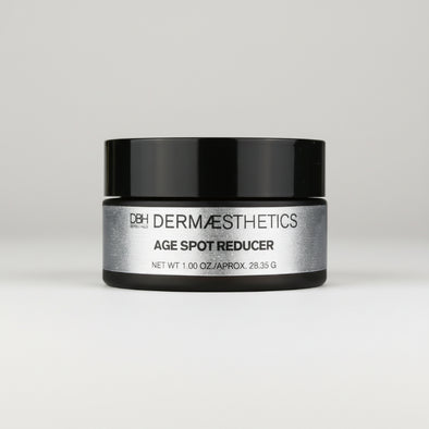 Dermaceutical jar labeled 'Age Spot Reducer' on a light gray background