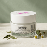 Derma Fix Hyaluronic Acid Cream jar styled with botanical leaves and chamomile flowers