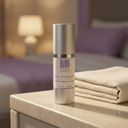 BiON Bio-Essence silver bottle on a stone vanity in warm evening light