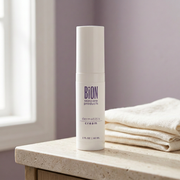 BiON Dermatitis Cream white bottle on a pale stone vanity beside ivory linen