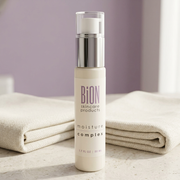 BiON Moisture Complex bottle on a pale stone vanity beside folded ivory linen