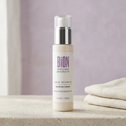 BiON Pure Mineral Sunscreen SPF 30 pump bottle on pale stone beside ivory linen